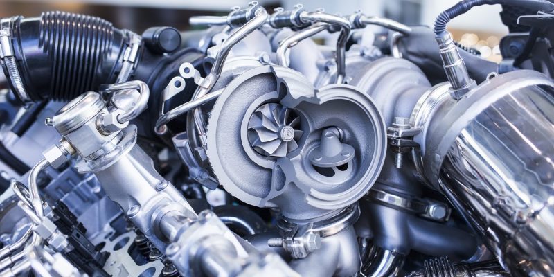 Disassembled parts of sports vehicle motor Turbo car engine showing parts and turbine dealer service workshop